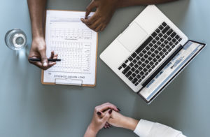 Aerial view of doctor writing patient daily report checklist