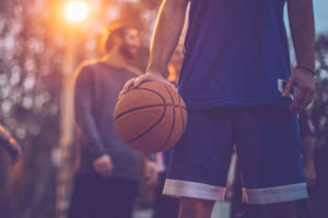 man palming basketball