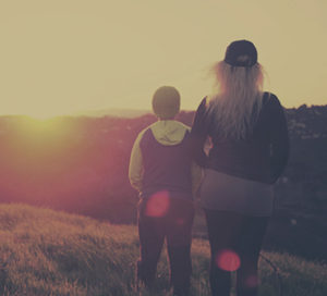 mom and son looking at sunset