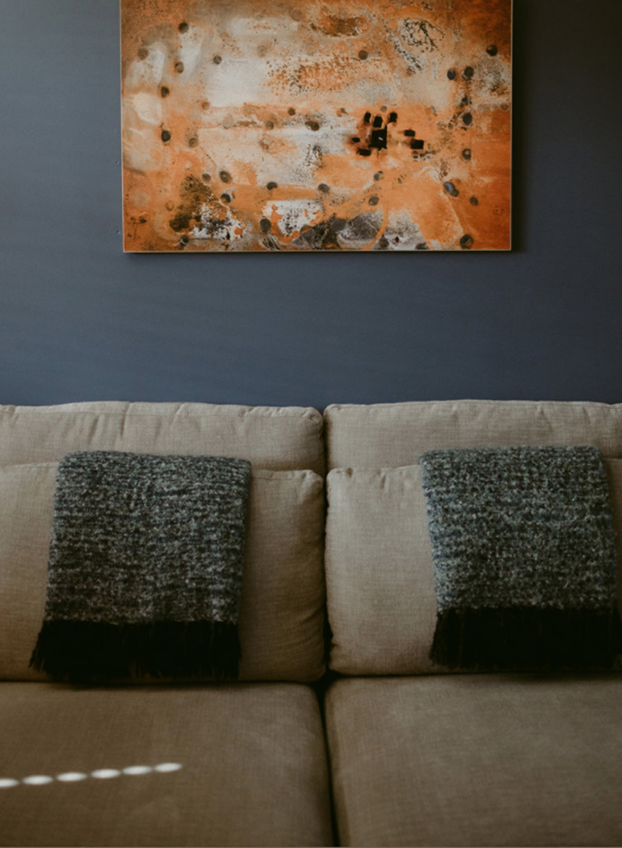 couch with artwork hanging above