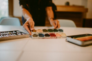 person setting water colors down