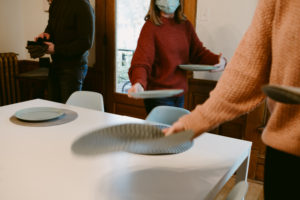 people setting a table with table mats