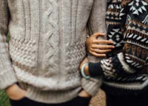 two people hooking arms