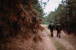 two men walking in the woods
