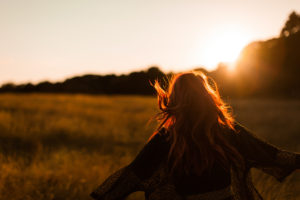 woman running into a sunset