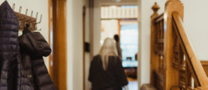 Person walking past coat rack