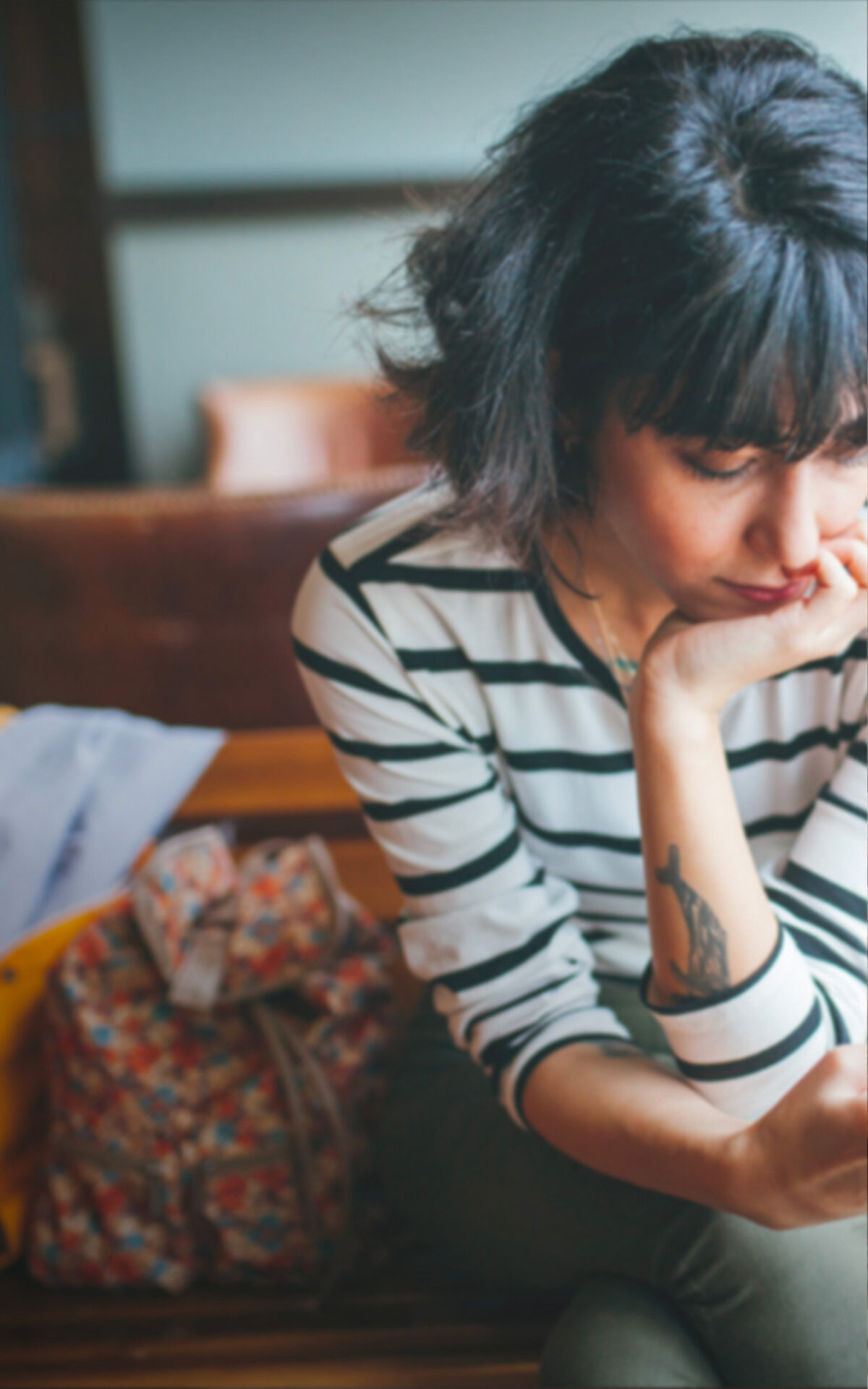 Woman sitting on couch looking at phone