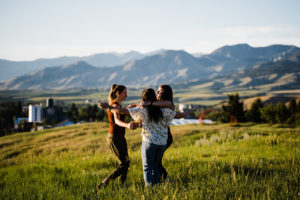 Girls hugging with a mountain background